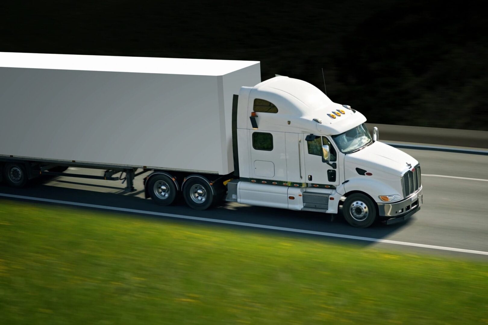 A white truck is driving down the road.